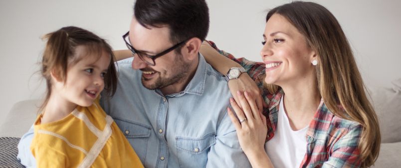 Young child with father and mother smiling