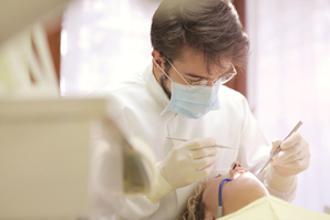 Dentist-looking-in-a-patients-mouth-January-blog-