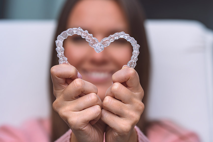 Girl holding 2 invisalign
