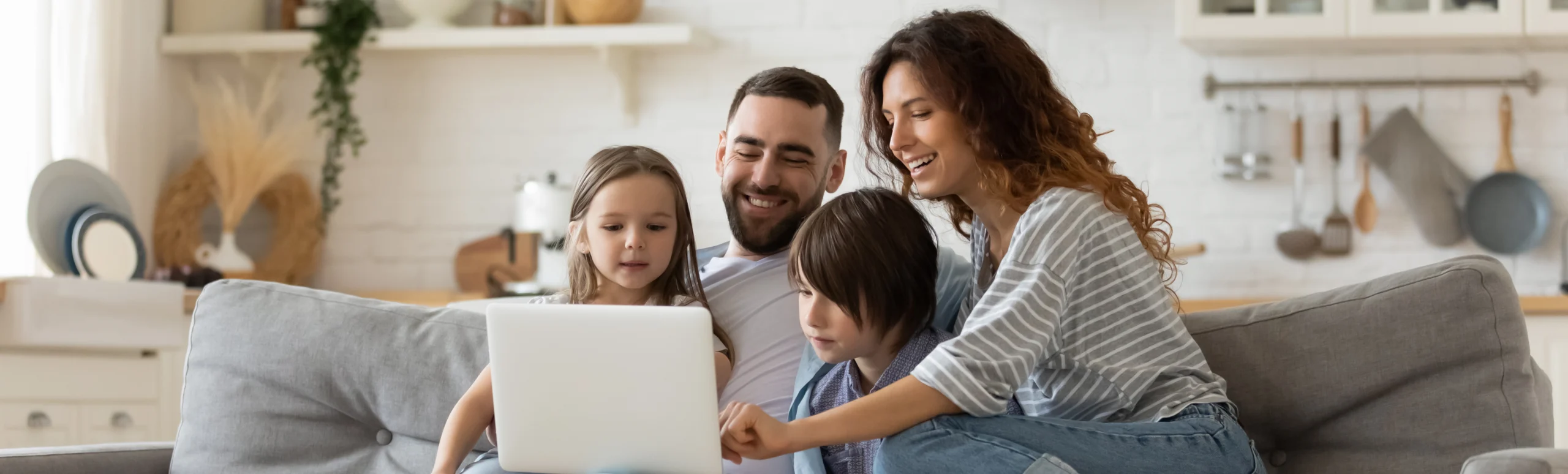 family at home using laptop